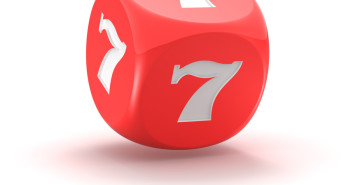 Red dice with lucky seven on the white background