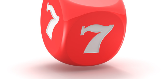 Red dice with lucky seven on the white background