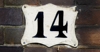 house number fourteen on a brick wall.