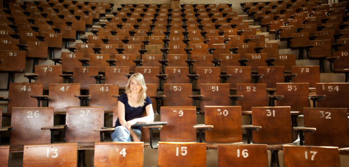 College student alone in large lecture hall