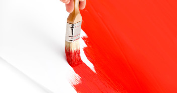 Brush painting red paint.