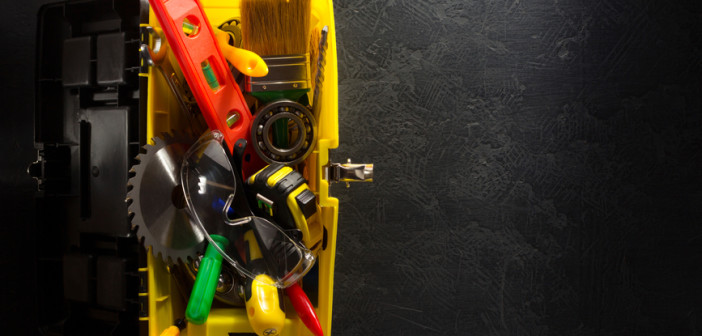 tools and instruments with toolbox on black background