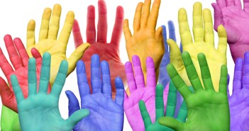 many colorful hands waving