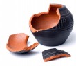 Broken antique clay pot on a white background