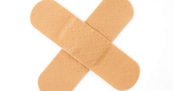two sticking plasters in a cross shape