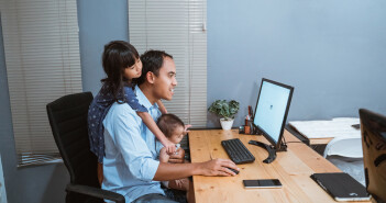 businessman working from home while babysitting. parent with child working at home