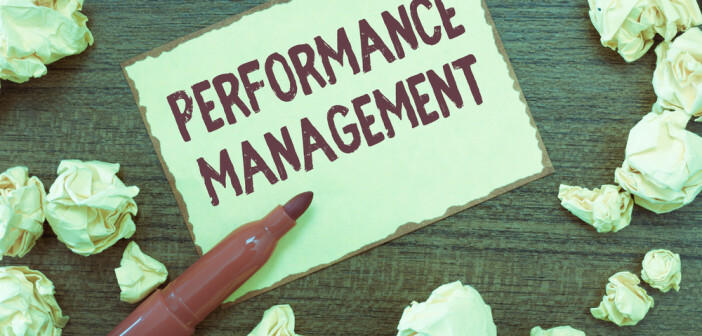 The words performance management written on a note