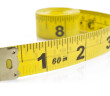 Yellow tape measure on rolled up on white background