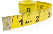 Yellow tape measure on rolled up on white background